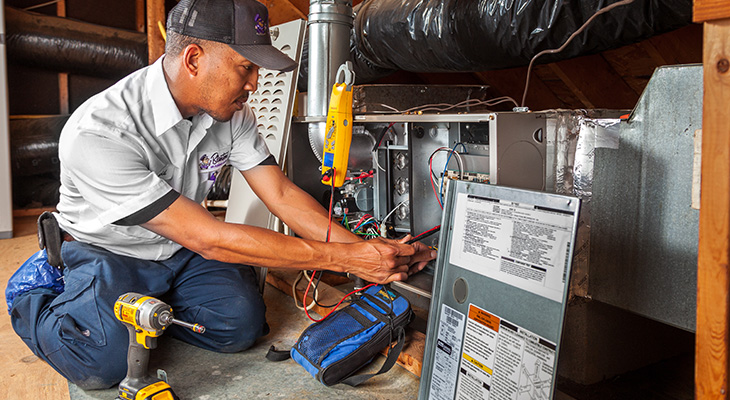 Blanton’s service professional working on a heating system in a Holly Springs home