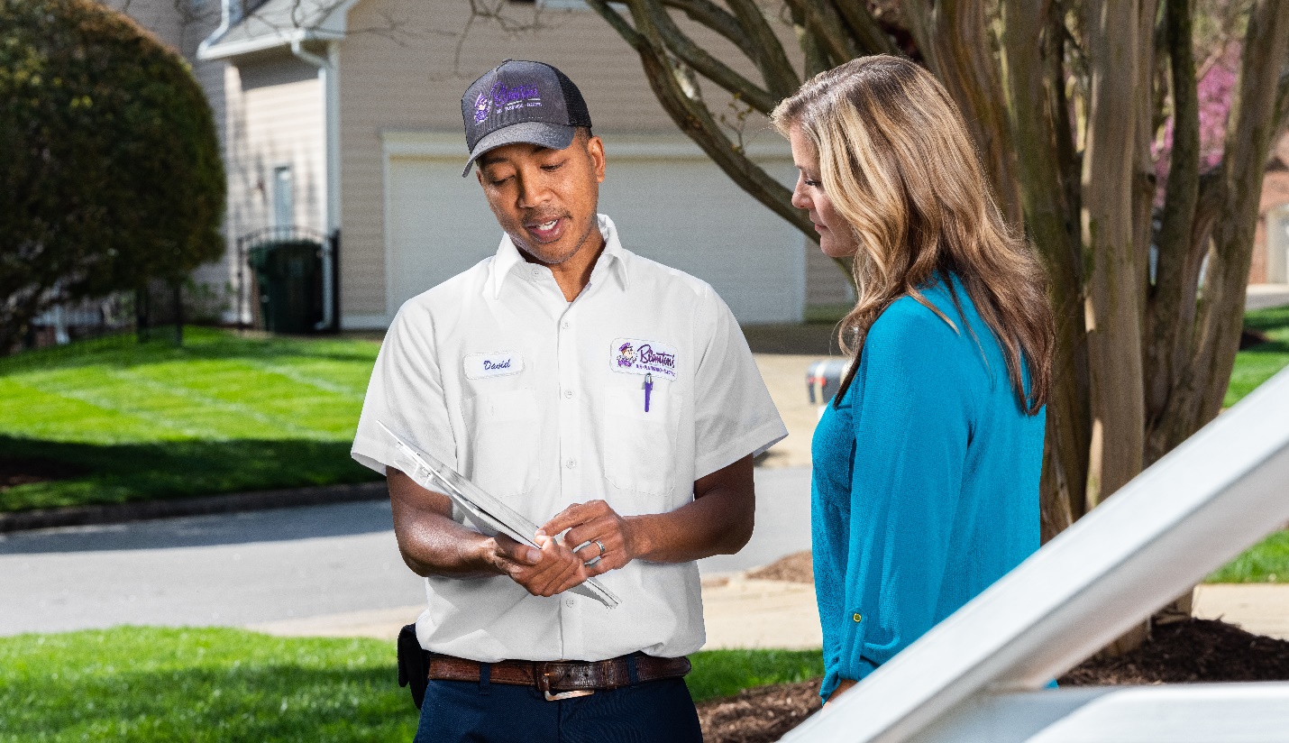 Blanton’s technician discussing heating services with a Cary homeowner