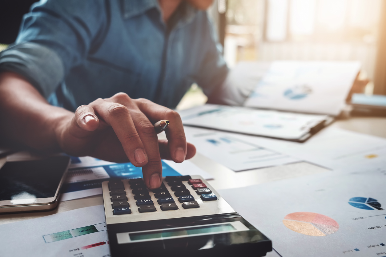 Man with calculator trying to figure out his energy bills
