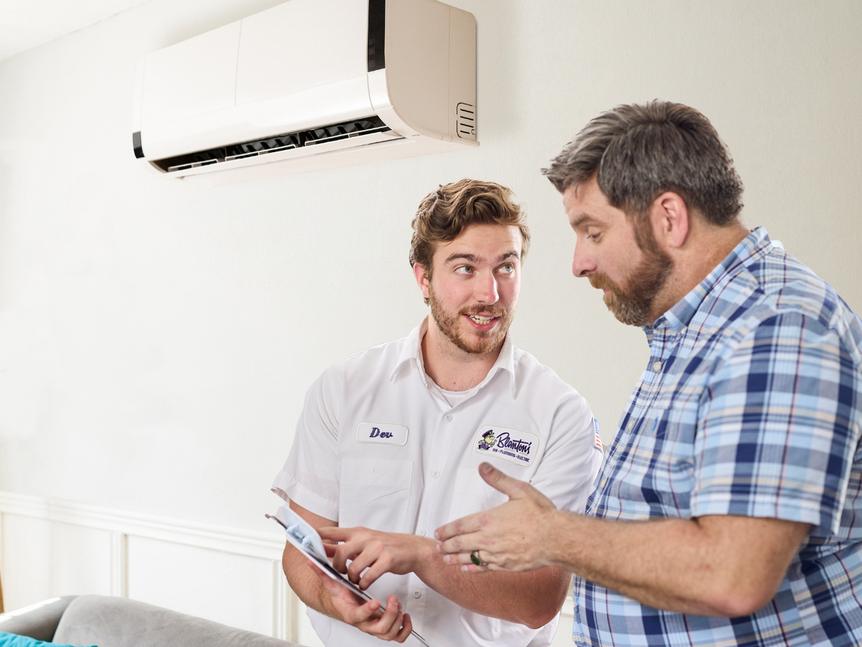 Blanton's service professional discussing ductless HVAC information with a homeowner
