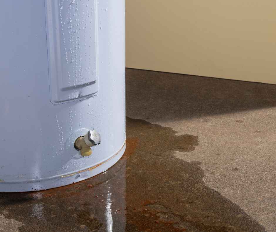 A water heater surrounded by water, meaning it is leaking