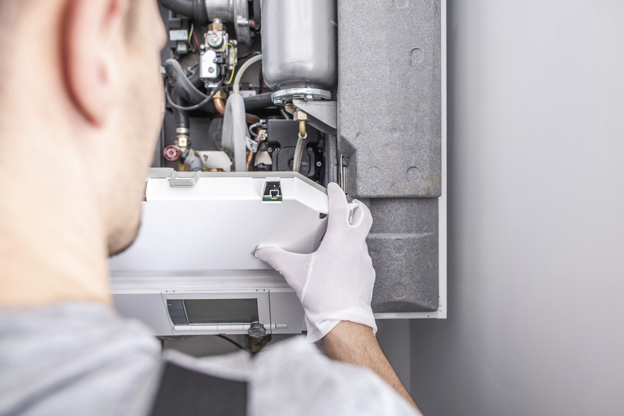 HVAC service professional installing a new gas heating system