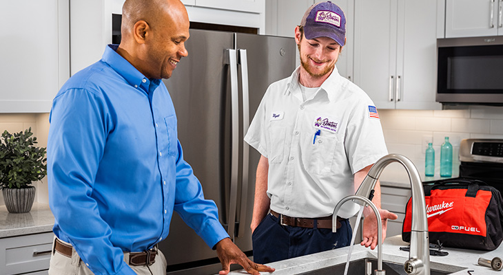 Blanton's service professional speaking with a homeowner about their kitchen plumbing