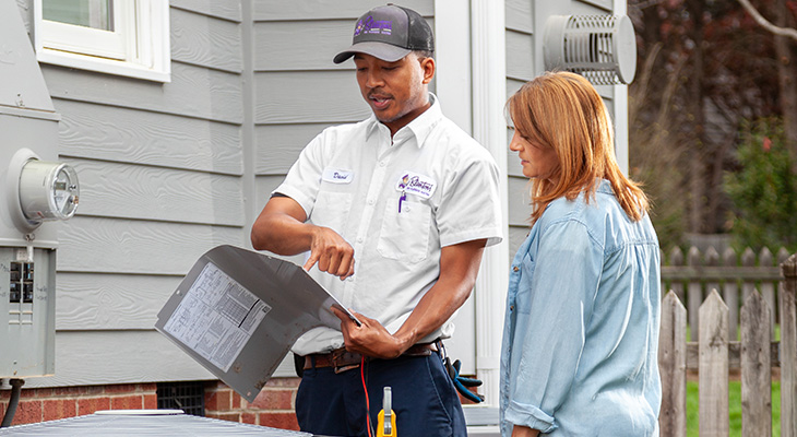 Blanton's service professional speaking with a homeowner about their HVAC unit