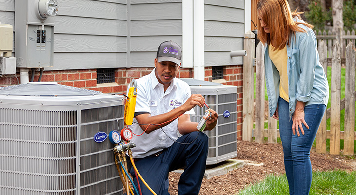 Blanton's service professional speaking with a home owner about their AC