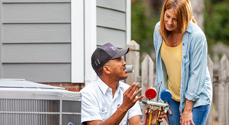 Blanton's service professional speaking with a homeowner about their AC