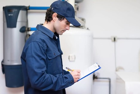 Service professional checking off a list during a water heater repair service