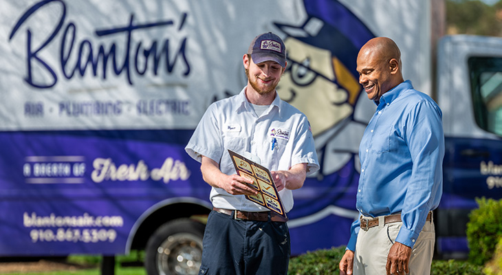 Blanton’s service professional speaking with an Apex homeowner about their home’s heating