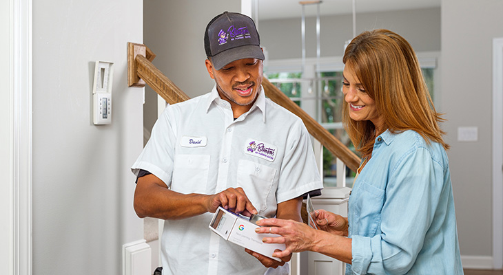 Blanton’s service professional speaking with a Garner homeowner about updating
their thermostat for a new heating system