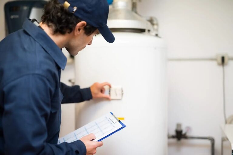 plumber installing a traditional water heater in NC home
