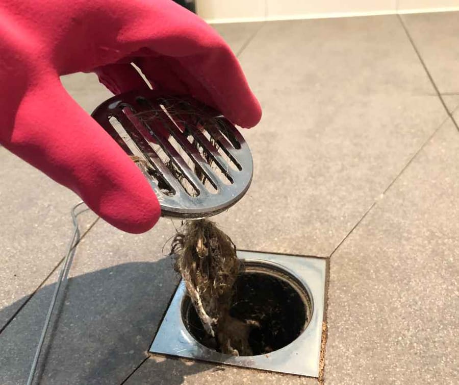 A severely clogged shower drain